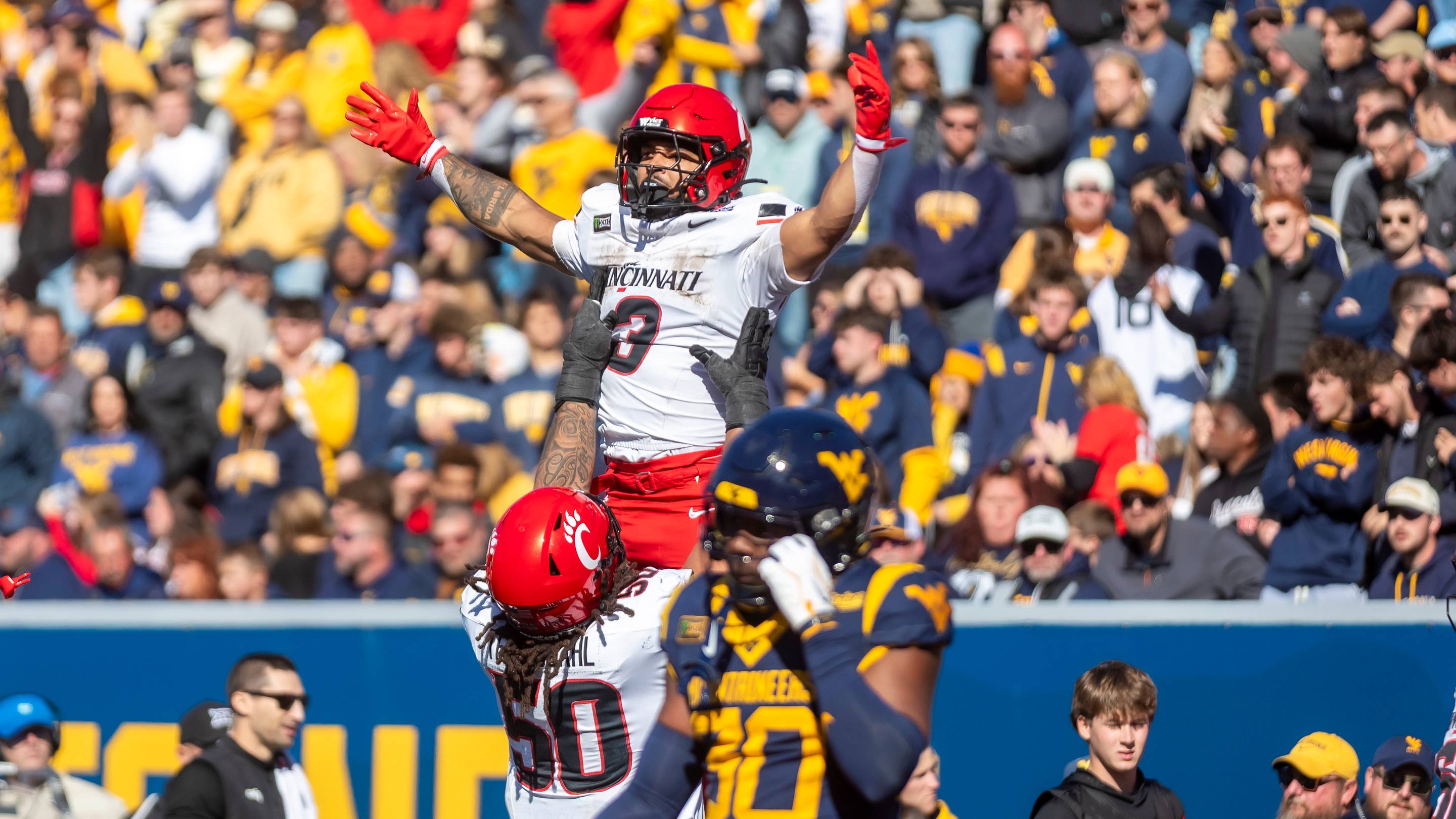 Oct 17, 2026; Morgantown, West Virginia, USA; Cincinnati Bearcats running back Cole Tabb (3) celebrates with offensive lineman Evan Tengesdahl (50) after a touchdown during the fourth quarter against the West Virginia Mountaineers at Milan Puskar Stadium. Mandatory Credit: Ben Queen-Imagn Images | I