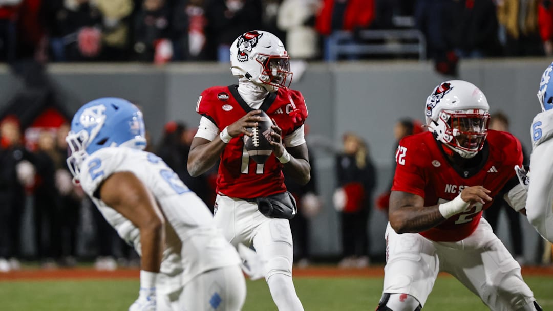 Nov 29, 2025; Raleigh, North Carolina, USA; NC State Wolfpack quarterback CJ Bailey (11) with the ball during the first half of the game against North Carolina Tar Heels at Carter-Finley Stadium.  Mandatory Credit: Jaylynn Nash-Imagn Images