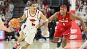 Dec 3, 2025; Fayetteville, Arkansas, USA; Arkansas Razorbacks guard Darius Acuff Jr (5) drives against Louisville Cardinals guard Ryan Conwell (3) during the first half at Bud Walton Arena. Mandatory Credit: Nelson Chenault-Imagn Images