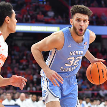 Jan 24, 2023; Syracuse, New York, USA; North Carolina Tar Heels forward Pete Nance (32) tries to move past Syracuse Orange center Jesse Edwards (14) in the first half at JMA Wireless Dome. Mandatory Credit: Mark Konezny-Imagn Images