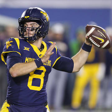 Oct 19, 2024; Morgantown, West Virginia, USA; West Virginia Mountaineers quarterback Nicco Marchiol (8) throws for a touchdown during the fourth quarter against the Kansas State Wildcats at Mountaineer Field at Milan Puskar Stadium. Mandatory Credit: Ben Queen-Imagn Images