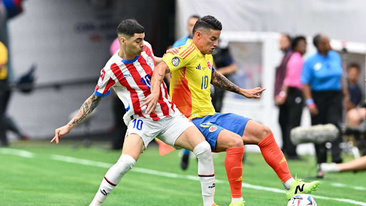 Jun 24, 2024; Houston, TX, USA; Colombia midfielder James Rodriguez (10) and Paraguay midfielder Miguel Almiron (10) battle for the ball during the first half at NRG Stadium. Mandatory Credit: Maria Lysaker-Imagn Images 