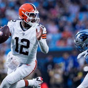 Aug 8, 2025; Charlotte, North Carolina, USA; Cleveland Browns quarterback Shedeur Sanders (12) gets away from Carolina Panthers defensive tackle Jaden Crumedy (96) during the second quarter at Bank of America Stadium. Mandatory Credit: Scott Kinser-The USAToday Network via Imagn Images 