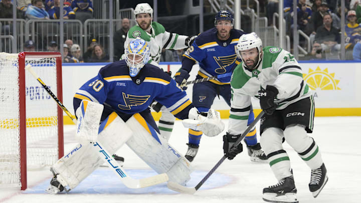Oct 18, 2025; St. Louis, Missouri, USA; St. Louis Blues goaltender Jordan Binnington (50) and defenseman Justin Faulk (72) defend the net from Dallas Stars center Colin Blackwell (15) and center Tyler Seguin (91) during the first period at Enterprise Center. Mandatory Credit: Jeff Le-Imagn Images