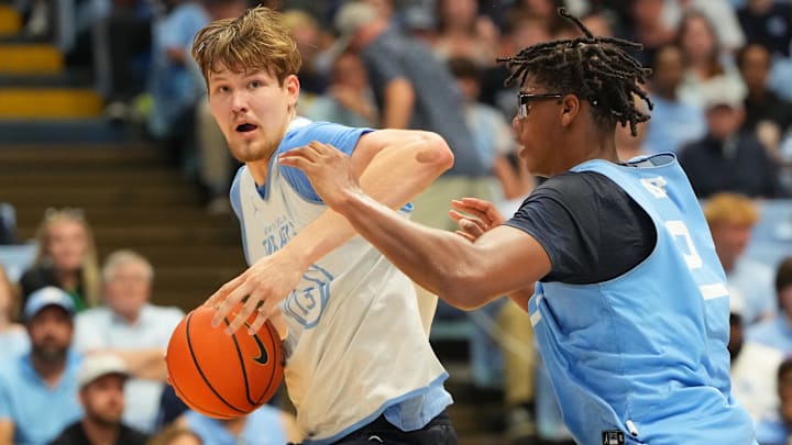 Oct 4, 2025; Charlotte, NC, USA; North Carolina Tar Heels center Henri Veesaar (13) with the ball as forward James Brown (2) defends in the first half at Dean E. Smith Center. Mandatory Credit: Bob Donnan-Imagn Images