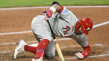 May 9, 2025; Cleveland, Ohio, USA; Philadelphia Phillies left fielder Kyle Schwarber (12) reacts to an inside pitch in the sixth inning against the Cleveland Guardians at Progressive Field