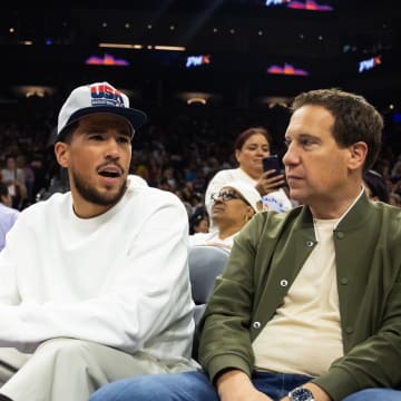 Jun 30, 2024; Phoenix, Arizona, USA; Phoenix Suns guard Devon Booker sits with Phoenix Mercury owner Mat Ishbia during the game between the Indiana Fever and the Phoenix Mercury at Footprint Center. Mandatory Credit: Mark J. Rebilas-USA TODAY Sports