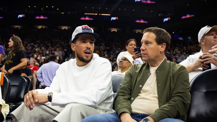 Jun 30, 2024; Phoenix, Arizona, USA; Phoenix Suns guard Devon Booker sits with Phoenix Mercury owner Mat Ishbia during the game between the Indiana Fever and the Phoenix Mercury at Footprint Center. Mandatory Credit: Mark J. Rebilas-USA TODAY Sports