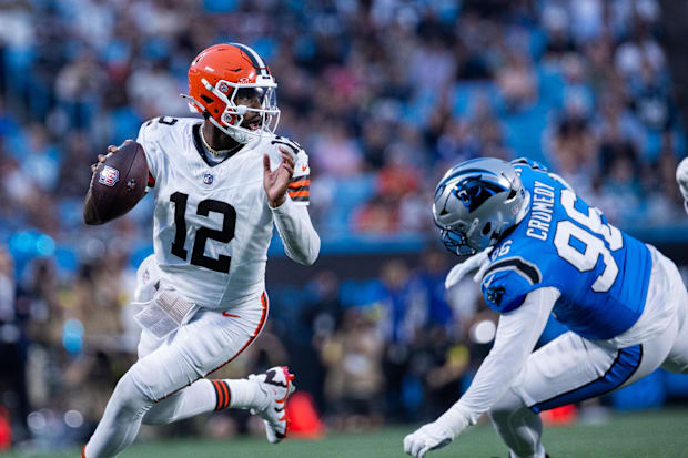 Browns quarterback Shedeur Sanders gets away Panthers defensive tackle Jaden Crumedy during the second quarter.