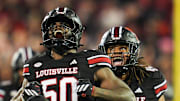 Louisville Cardinals defensive lineman Clev Lubin (50) celebrates his tackle of Clemson Tigers quarterback Cade Klubnik (2) in the first half at L&N Stadium Friday, Nov. 14, 2025.