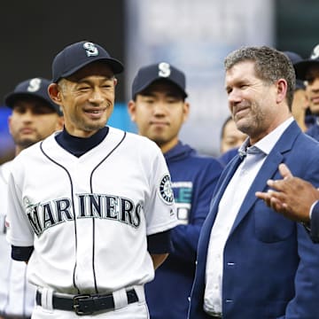 Sep 14, 2019; Seattle, WA, USA; Seattle Mariners former outfielder Ichiro Suzuki, left, reacts with former designated hitter Edgar Martinez, middle, and former outfielder Ken Griffey, Jr., right, at the conclusion of a ceremony honoring Suzuki with the franchise achievement award before a game against the Chicago White Sox at T-Mobile Park. Mandatory Credit: Joe Nicholson-Imagn Images
