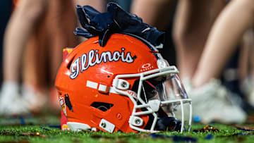 Dec 31, 2024; Orlando, FL, USA; A Illinois Fighting Illini helmet sitting on confetti after the game against the South Carolina Gamecocks at Camping World Stadium. Mandatory Credit: Jeremy Reper-Imagn Images