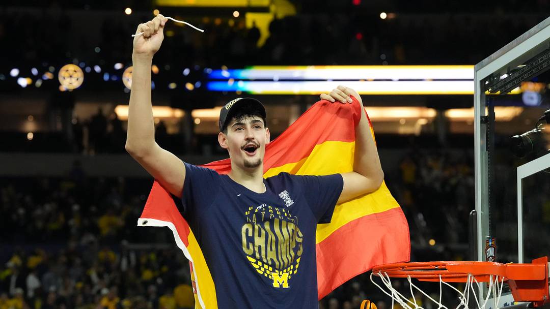Apr 6, 2026; Indianapolis, IN, USA; Michigan Wolverines center Aday Mara (15) celebrates after cutting down a piece of the net after defeating the Connecticut Huskies in the national championship of the Final Four of the men's 2026 NCAA Tournament at Lucas Oil Stadium. Mandatory Credit: Robert Deutsch-Imagn Images