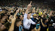 Oregon Ducks head coach Dan Lanning celebrates amid a crowd of fans on the field as the No. 3 Oregon Ducks knock off the No. 2 Ohio State Buckeyes 32-31 Saturday, Oct. 12, 2024 at Autzen Stadium in Eugene, Ore.