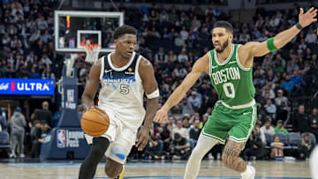 Jan 2, 2025; Minneapolis, Minnesota, USA; Minnesota Timberwolves guard Anthony Edwards (5) dribbles past Boston Celtics forward Jayson Tatum (0) in the second half at Target Center. Mandatory Credit: Jesse Johnson-Imagn Images