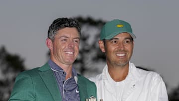 Apr 13, 2025; Augusta, Georgia, USA; Rory McIlroy holds the Masters championship trophy while posing for photographs with his caddie, Harry Diamond, at the green jacket ceremony during the final round of the Masters Tournament at Augusta National Golf Club. Mandatory Credit: Kyle Terada-Imagn Images