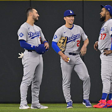 Apr 20, 2025; Arlington, Texas, USA; Los Angeles Dodgers left fielder Michael Conforto (23) and center fielder Tommy Edman (25) and right fielder Teoscar Hernandez (37) during the game between the Texas Rangers and the Los Angeles Dodgers at Globe Life Field. Mandatory Credit: Jerome Miron-Imagn Images