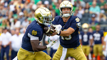 Sep 20, 2025; South Bend, Indiana, USA; Notre Dame Fighting Irish quarterback CJ Carr (13) hands off to Notre Dame Fighting Irish running back Jeremiyah Love (4) against the Purdue Boilermakers during the first half at Notre Dame Stadium. Mandatory Credit: Michael Caterina-Imagn Images