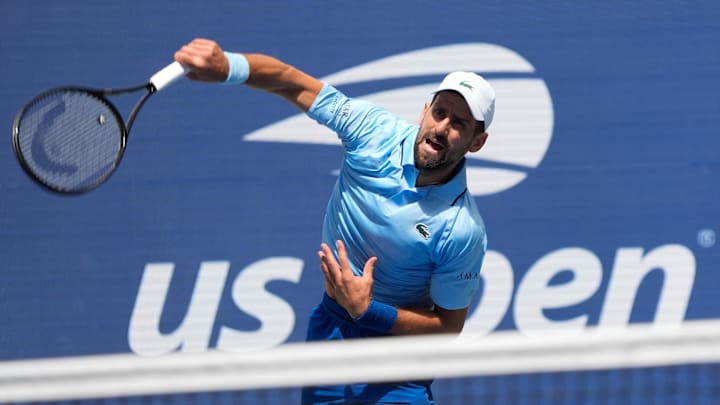 Novak Djokovic hits to Zachary Svajda