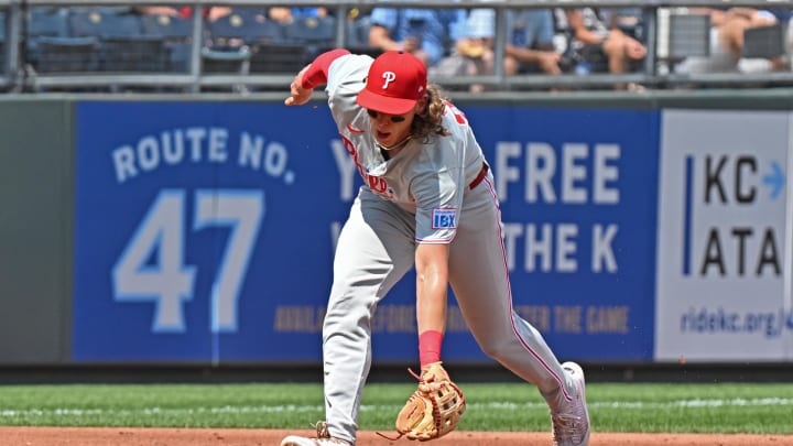 Aug 25, 2024; Kansas City, Missouri, USA;  Philadelphia Phillies third baseman Alec Bohm (28) fields a ground ball in the second inning against the Kansas City Royals at Kauffman Stadium. 