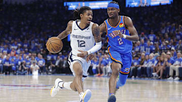 Apr 22, 2025; Oklahoma City, Oklahoma, USA; Memphis Grizzlies guard Ja Morant (12) drives to the basket beside Oklahoma City Thunder guard Shai Gilgeous-Alexander (2) in the third quarter during game two of first round for the 2024 NBA Playoffs at Paycom Center. Mandatory Credit: Alonzo Adams-Imagn Images