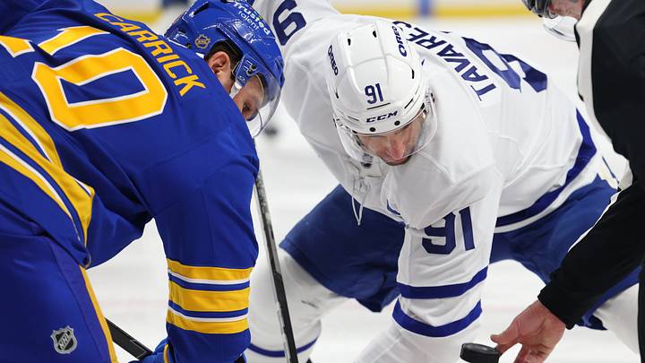 Buffalo Sabres center Sam Carrick (10) and Toronto Maple Leafs center John Tavares (91) take a face-off during the first period at KeyBank Center. Mandatory Credit: Timothy T. Ludwig-Imagn Images