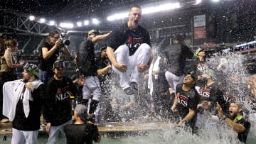 Diamondbacks closer Paul Sewald cannonballs into the Chase Field pool to celebrate an NLDS sweep of the LA Dodgers