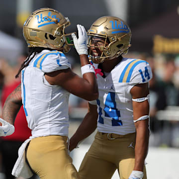 Aug 31, 2024; Honolulu, Hawaii, USA; UCLA Bruins wide receiver Rico Flores Jr. (1) reacts with defensive back Clint Stephens (14) after Flores Jr. made a touchdown against the Hawaii Rainbow Warriors during the third quarter of an NCAA college football game against the UCLA Bruins at the Clarence T.C. Ching Athletics Complex. Mandatory Credit: Marco Garcia-Imagn Images