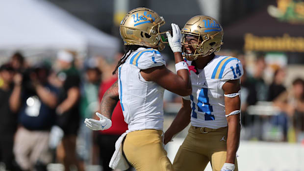 Aug 31, 2024; Honolulu, Hawaii, USA; UCLA Bruins wide receiver Rico Flores Jr. (1) reacts with defensive back Clint Stephens 