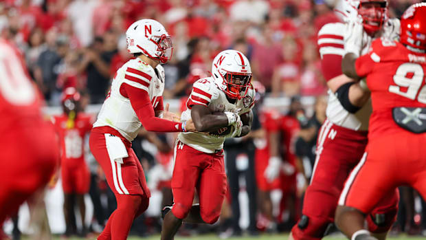 Nebraska quarterback Dylan Raiola hands the ball off to running back Emmett Johnson.