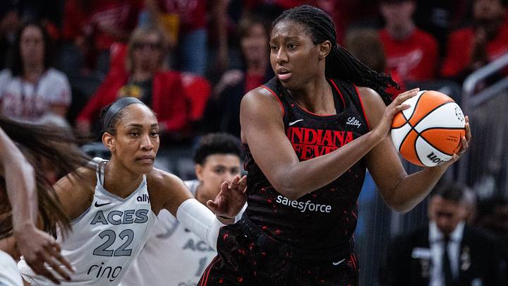 Sep 28, 2025; Indianapolis, Indiana, USA; Indiana Fever forward Aliyah Boston (7) holds the ball while Las Vegas Aces center A'ja Wilson (22) defends in the second half  during game four of the second round for the 2025 WNBA Playoffs at Gainbridge Fieldhouse. Mandatory Credit: Trevor Ruszkowski-Imagn Images
