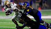 St. Augustine's Devonte Lyons (6) is tackled by Brunswick's Mike Daniels Jr. (34), right top, and Donyea Broughton (88), bottom, during the first quarter of the Florida-Georgia Border Classic high school football matchup Saturday, Sept. 9, 2023 at Glynn County Stadium in Brunswick, Ga. The St. Augustine Yellow Jackets held off the Brunswick Pirates 45-35.