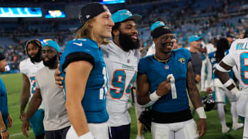 Jacksonville Jaguars quarterback Trevor Lawrence (16), from left, Miami Dolphins defensive tackle Christian Wilkins (94) and Jacksonville Jaguars running back Travis Etienne Jr. (1), all former Clemson University teammates, pose for a photo after the game of a preseason matchup Saturday, Aug. 26, 2023 at EverBank Stadium in Jacksonville, Fla. The game was suspended in the fourth after Miami Dolphins wide receiver Daewood Davis (87) was injured on a play with a final score of 31-18.