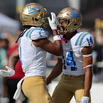 UCLA Bruins wide receiver Rico Flores Jr. (1) reacts with defensive back Clint Stephens (14) after Flores Jr. made a touchdown against the Hawaii Rainbow Warriors during the third quarter of an NCAA college football game against the UCLA Bruins at the Clarence T.C. Ching Athletics Complex.