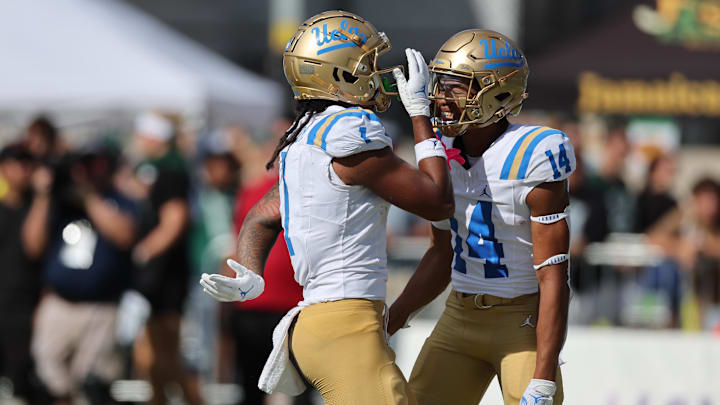 UCLA Bruins wide receiver Rico Flores Jr. (1) reacts with defensive back Clint Stephens (14) after Flores Jr. made a touchdown against the Hawaii Rainbow Warriors during the third quarter of an NCAA college football game against the UCLA Bruins at the Clarence T.C. Ching Athletics Complex.