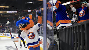 Feb 4, 2022; Las Vegas, Nevada, USA; New York Islanders    mascot Sparky scores a goal and celebrates with New York fans in the mascot game during the 2022 NHL All-Star Game Skills Competition at T-Mobile Arena. Mandatory Credit: Aaron Doster-Imagn Images