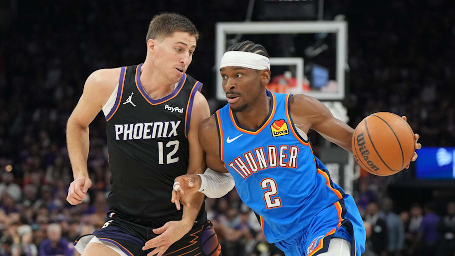 Thunder guard Shai Gilgeous-Alexander drives on Suns guard Collin Gillespie.