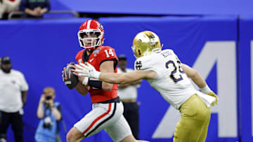 Jan 2, 2025; New Orleans, LA, USA; Georgia Bulldogs quarterback Gunner Stockton (14) controls the ball during the first quarter against Notre Dame Fighting Irish linebacker Jack Kiser (24) at Caesars Superdome. Mandatory Credit: Amber Searls-Imagn Images