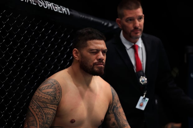 Justin Tafa squints after he suffered a cut near his eye in a heavyweight bout during a UFC Fight Night event.