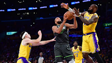 Minnesota Timberwolves center Rudy Gobert gets rebound against Los Angeles Lakers guard Austin Reaves and LeBron James 