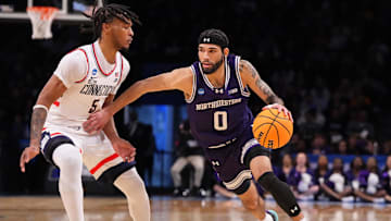 Mar 24, 2024; Brooklyn, NY, USA; Northwestern Wildcats guard Boo Buie (0) dribbles the ball past Connecticut Huskies guard Stephon Castle (5) in the second round of the 2024 NCAA Tournament at the Barclays Center. Mandatory Credit: Robert Deutsch-Imagn Images