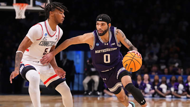 Mar 24, 2024; Brooklyn, NY, USA; Northwestern Wildcats guard Boo Buie (0) dribbles the ball past Connecticut Huskies guard Stephon Castle (5) in the second round of the 2024 NCAA Tournament at the Barclays Center. Mandatory Credit: Robert Deutsch-Imagn Images