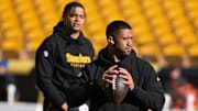 Dec 8, 2024; Pittsburgh, Pennsylvania, USA; Pittsburgh Steelers quarterback Russell Wilson throws the ball as Justin Fields looks during warm ups for a game against the Cleveland Browns at Acrisure Stadium. Mandatory Credit: Barry Reeger-Imagn Images