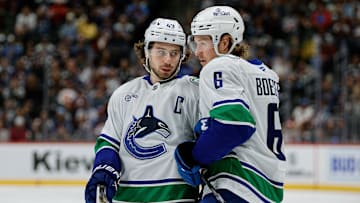 Apr 10, 2025; Denver, Colorado, USA; Vancouver Canucks defenseman Quinn Hughes (43) and right wing Brock Boeser (6) in the first period against the Colorado Avalanche at Ball Arena. Mandatory Credit: Isaiah J. Downing-Imagn Images