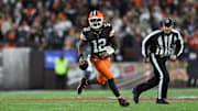 Nov 16, 2025; Cleveland, Ohio, USA; Cleveland Browns quarterback Shedeur Sanders (12) runs for a gain during the fourth quarter against the Baltimore Ravens at Huntington Bank Field. Mandatory Credit: Scott Galvin-Imagn Images