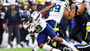 Nov 16, 2025; Inglewood, California, USA; Seattle Seahawks running back Kenneth Walker III (9) runs the ball against Los Angeles Rams safety Kam Curl (3) during the second half at SoFi Stadium. Mandatory Credit: Gary A. Vasquez-Imagn Images