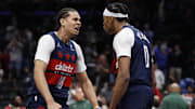 Dec 1, 2025; Washington, District of Columbia, USA; Washington Wizards guard Bilal Coulibaly (0) celebrates with Wizards forward Kyshawn George (18) after scoring while being fouled by Milwaukee Bucks forward Giannis Antetokounmpo (not pictured) in the final seconds of the fourth quarter at Capital One Arena. Mandatory Credit: Geoff Burke-Imagn Images