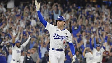 Oct 25, 2024; Los Angeles, California, USA; Los Angeles Dodgers first baseman Freddie Freeman (5) celebrates after hitting a grand slam home run in the tenth inning against the New York Yankees during game one of the 2024 MLB World Series at Dodger Stadium. Mandatory Credit: Jayne Kamin-Oncea-Imagn Images