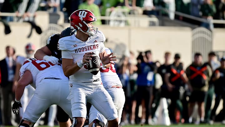 Nov 2, 2024; East Lansing, Michigan, USA;  Indiana Hoosiers quarterback Kurtis Rourke (9) looks for a receiver during the second quarter against the Michigan State Spartans at Spartan Stadium. Mandatory Credit: Dale Young-Imagn Images