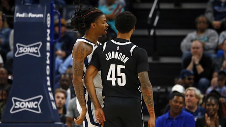 Ja Morant talks to Keon Johnson during the Grizzlies - Nets game.